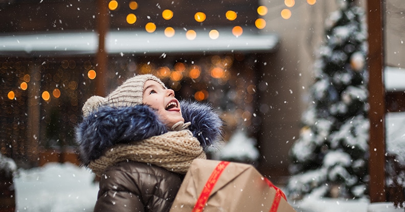 Enfant portant un cadeau et flocons de neige